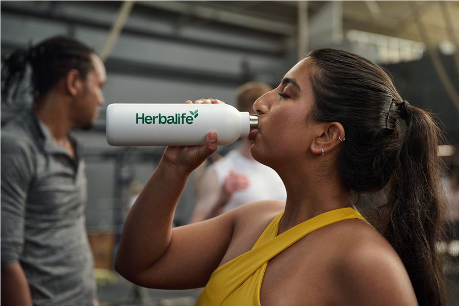 Herbalife bottle in an active lifestyle setting