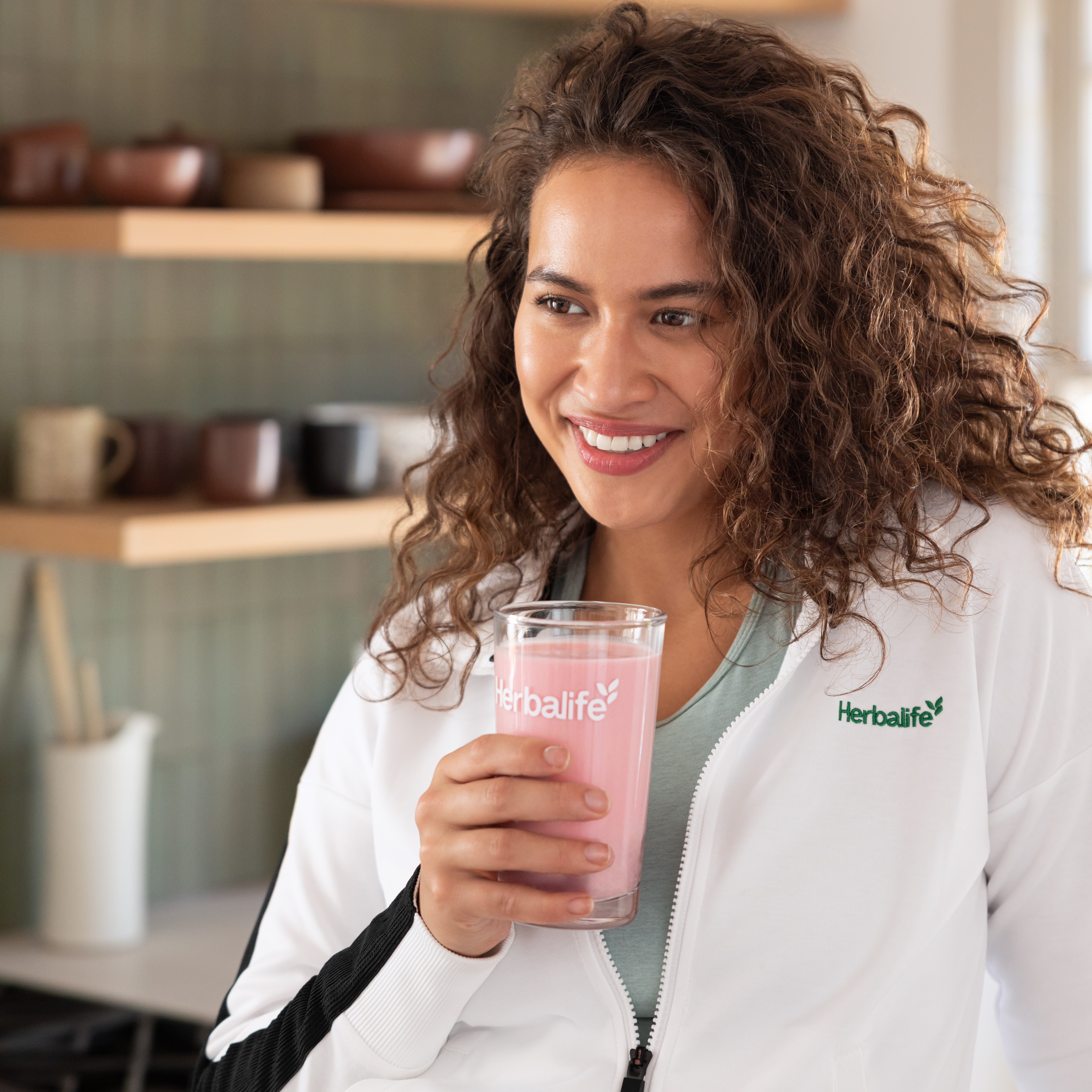 Woman drinking Formula 1 shake at home